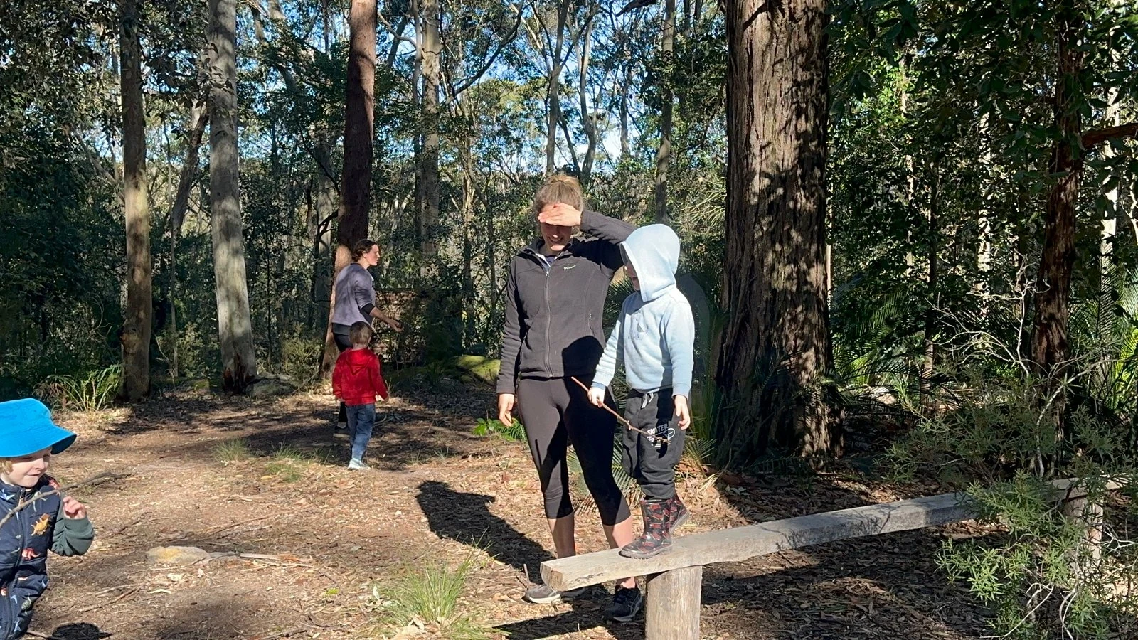 Children exploring outdoor play equipment at Adventure OT.